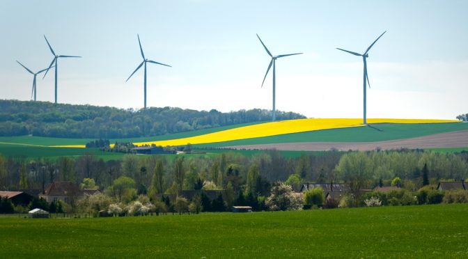 How do communities all over Europe benefit from having a wind farm nearby?